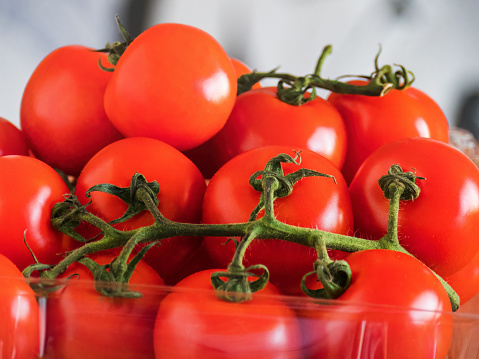 Fresh, ripe vine-ripened red tomatoes available on the grocery store shelf