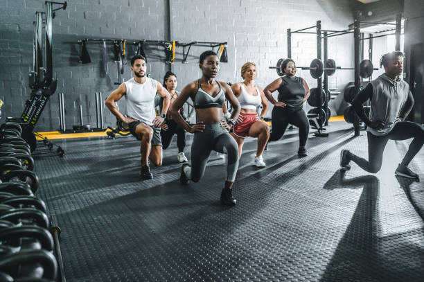 istock Group of athletes focusing on doing lunges in gym 1494134862