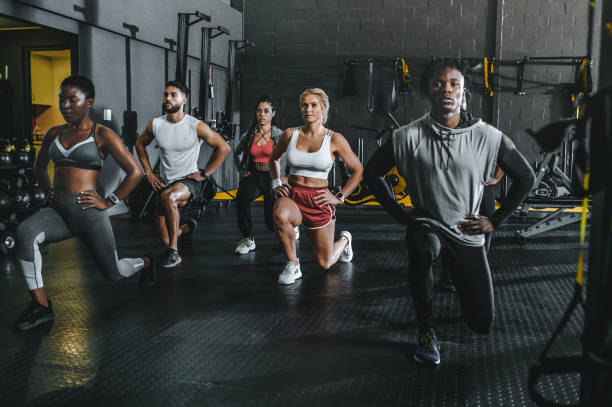 istock Multiracial group of athletes concentrating on doing lunges in gym 1494134867