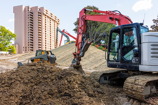 Sand and gravel: essential materials for a building project. Bulldozers and backhoes: the dynamic duo of construction in Downtown of Newport News, VA
