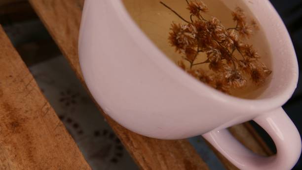 istock Tea ready to drink. Small tea table. A tea day. Hot drink. Infusion time: a tea cup close-up shot - Macela (Achyrocline satureioides). Hot cup of tea. A big tea jar 1494136724