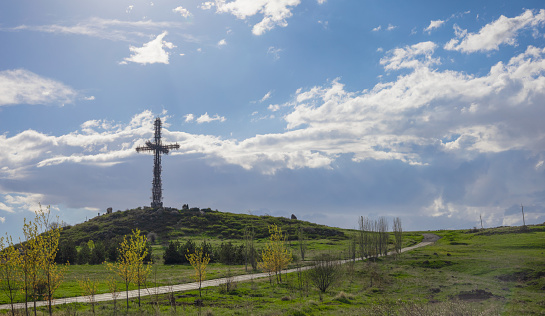 Armenia - April 30, 2023: Giant iron metallic cross made by many small crosses located on the top of the hill near Aparan
