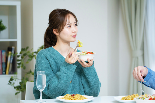 Japanese woman eating breakfast at home