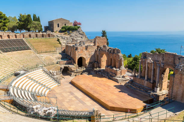 Ancient Greek theater in Taormina, Sicily Ruins of the ancient Greek theater in Taormina, Sicily, Italy in a beautiful summer day greek amphitheater stock pictures, royalty-free photos & images