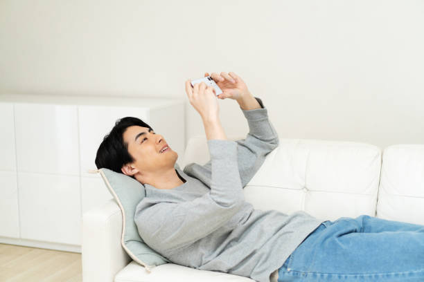 Japanese man watching his phone at home