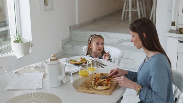 Mother and daughter bond over lunch at a restaurant