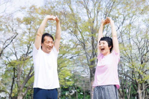 istock Mature Japanese couple stretching in a park 1494145607