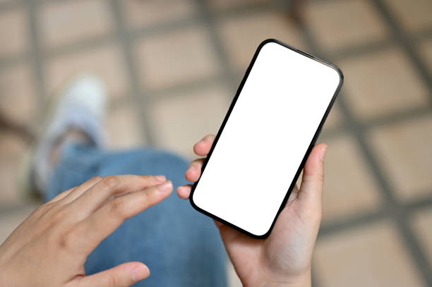 istock A female using her smartphone while relaxing outdoors. Smartphone white screen mockup 1494146167