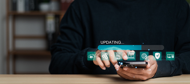 Man installing update process. Software updates or operating system upgrades to keep your device up to date with enhanced functionality in new versions and improved security, Operating system upgrade concept.