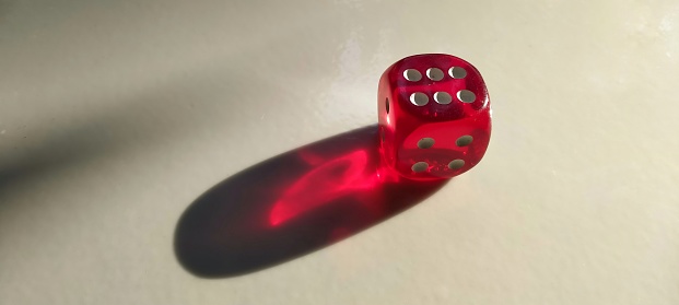 The transparent red dice are exposed to light from the side