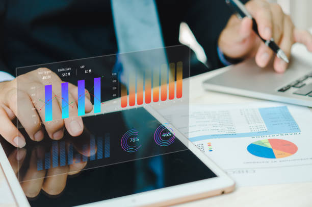 istock Businessman using tablet with statistics, graph and chart virtual hologram of statistics.Data analytics and statistics. business marketing investment and financial concept. 1494150179