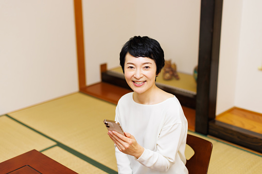 Mature Japanese woman with a mobile phone