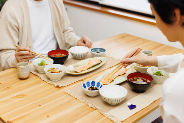istock Two people with Japanese food on dining table 1494150869