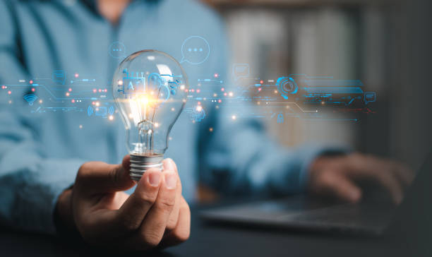istock Businessman holding light bulb with Ai brain inside, business networking technology innovation, idea and imagination, creativity and inspiration. 1494151296