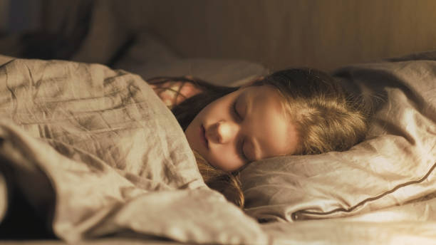 istock Kid rest night bedtime peaceful girl sleeping bed 1494154793
