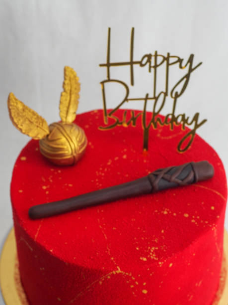 istock red painted frosted cake with golden topping 1494155164