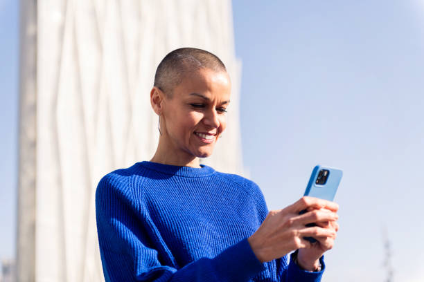 istock confident woman in blue sweater using mobile phone 1494155222