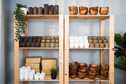 Many groups of handmade wooden vase stock on the shelf at the vase store. Vase stock is ready for delivery for online customers on the shelf for souvenirs or home decoration.
