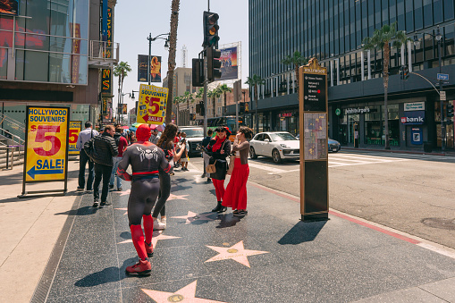 Los Angeles, California, USA - April 26, 2023. Crowded Hollywood Walk of Fame. Stars, street performances, and tourists