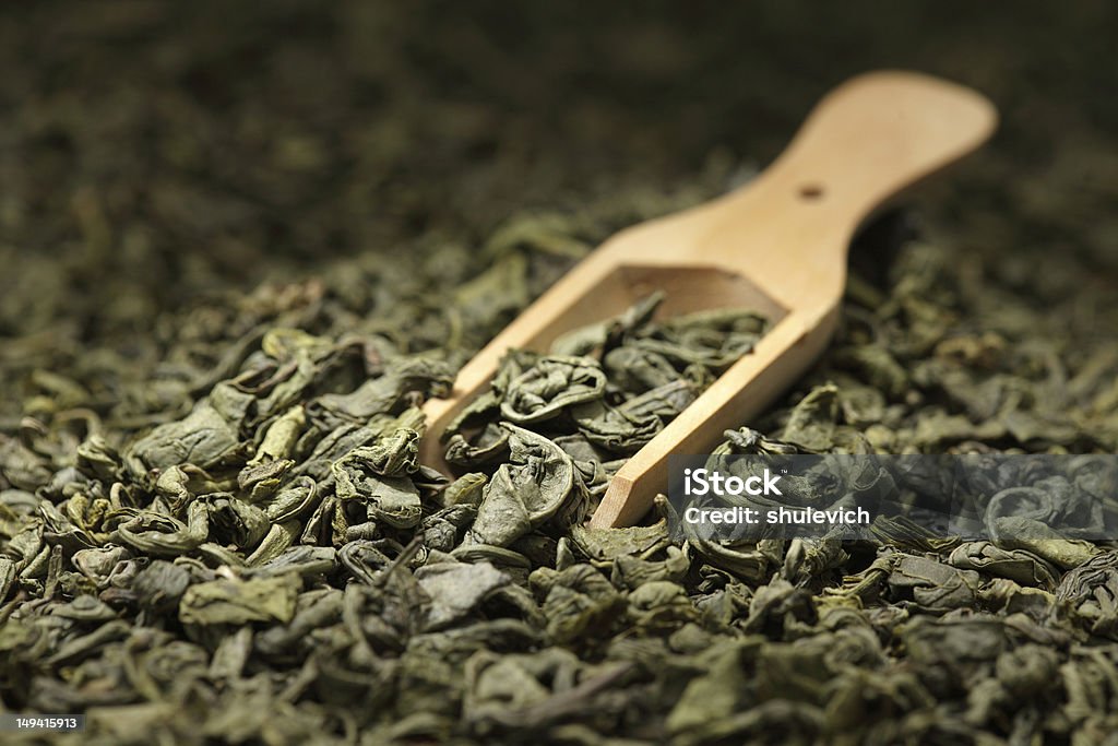 Green tea leaves with wooden scoop Green tea leaves Antioxidant Stock Photo