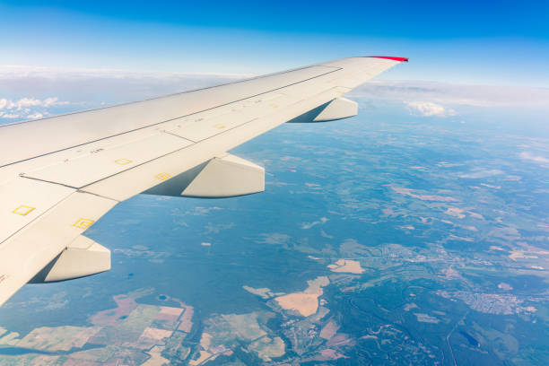 istock View from the airplane window at a beautiful cloudy sky and the airplane wing 1494162096