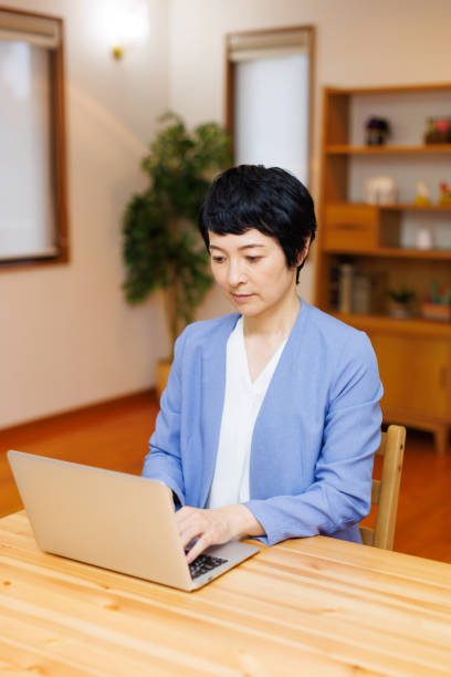 istock Mature Japanese woman working from home 1494162902