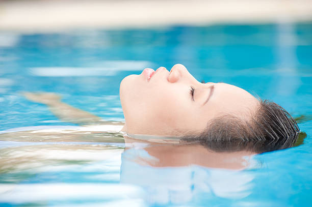 istock A woman relaxing in pool water 149416367