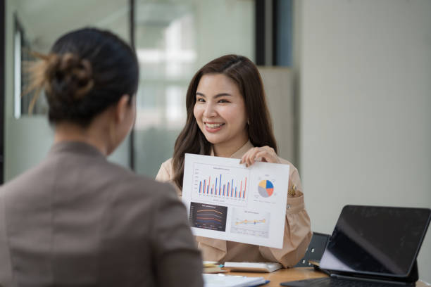 istock Two Young Asian businesswomen discuss with new startup project Idea presentation and analyze planning and financial statistics and investment market at an office. 1494166731