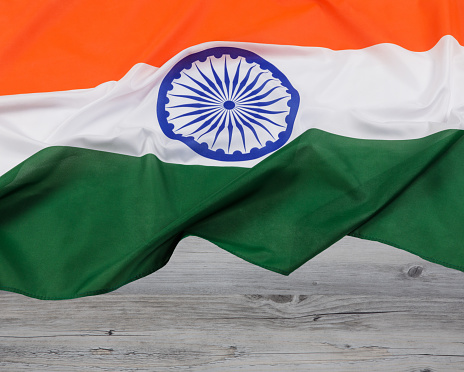 Official flag of the South Asian country of Republic of India, more commonly known as India with a wooden background with copy space