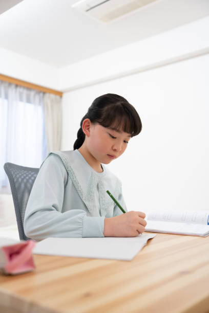 istock Japanese girl studying at home 1494168459