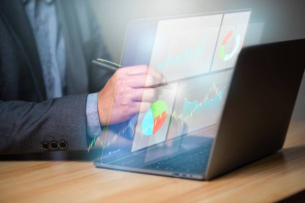 istock Business developmetn and tecnology concept. Businessman using laptop with technical growing up graph on virtual hologram display. Planning and strategy, Financial investment and trading. 1494169428
