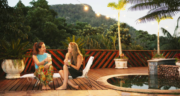 istock Friends talking over cocktails while sitting on a patio on a summer evening 1494180743