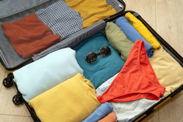 istock Top down view of a suitcase prepared for seaside vacation. 1494187606