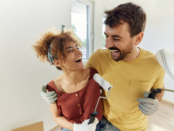 istock Cheerful couple having fun during home renovation process. 1494187950