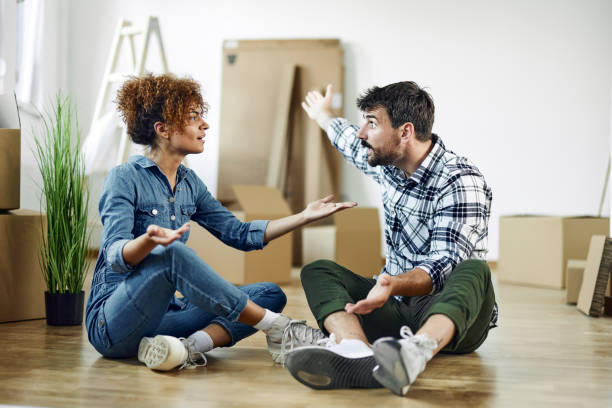 istock Young couple arguing after relocating into new apartment. 1494188433