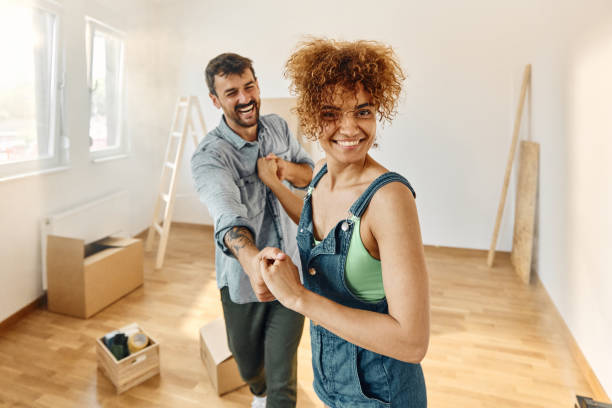 istock Happy couple dancing after moving into a new apartment. 1494189184