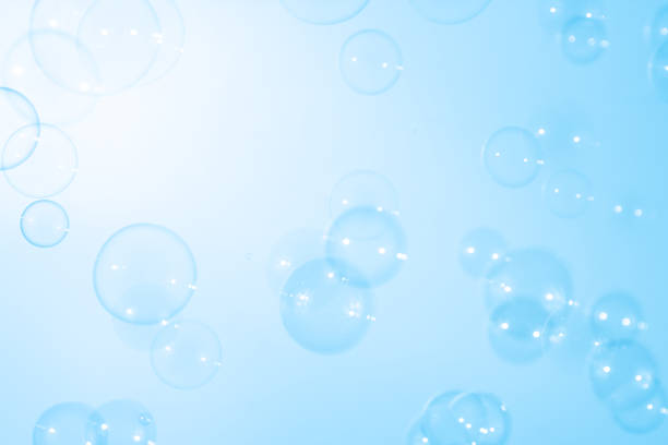 Beautiful Defocused Transparent Blue Soap Bubbles. Abstract Background. White Space. Celebration Festive Backdrop. Freshness Soap Suds Bubbles Water