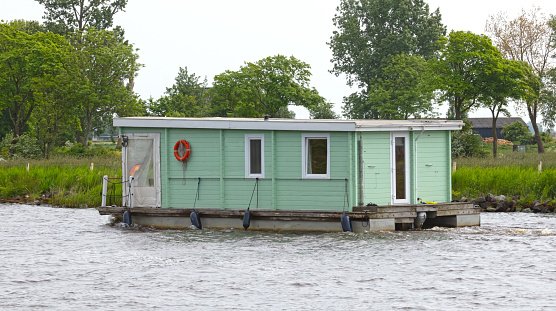 Houseboat on the move in the Netherlands, canal