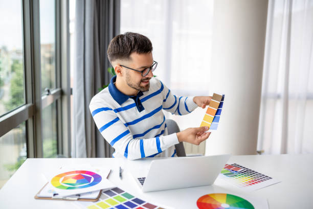 istock web designer working from home, sitting at table with modern laptop, looking at color samples, happy man freelancer enjoying his remote job, copy space 1494196077