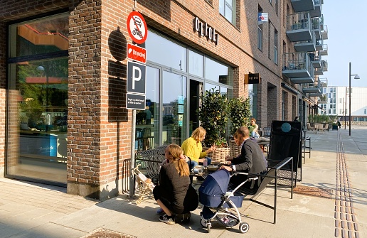 The photo was taken outside a cafe on May 26th, 2023 in a new fashionable district by the sea in Nordhavn, Copenhagen, Denmark. Residential apartments are mixed with office buildings and business making the area  attractive and very much alive.
