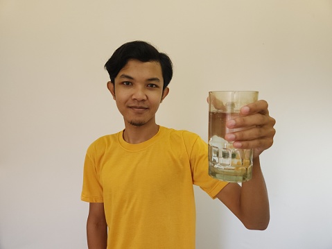 Asian man is drinking water isolated on white background