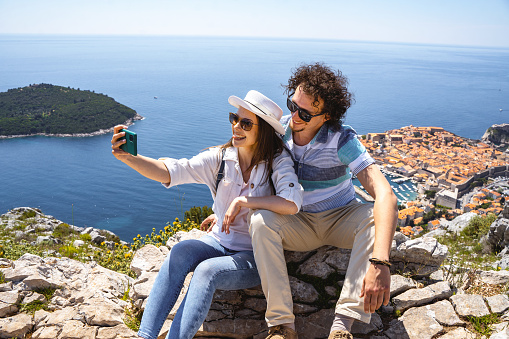 Man and woman taking selfie at the viewpoint of Dubrovnik