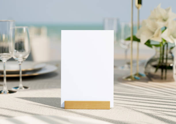 istock Mockup white blank space card, for greeting, table number, wedding invitation template on wedding table setting background. with clipping path. 1494202382