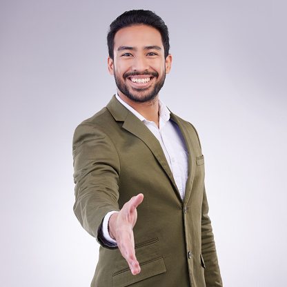 Greeting or portrait of businessman handshake gesture with a smile and happy isolated in a studio white background. Professional, employee and man corporate worker shaking hand offer to welcome