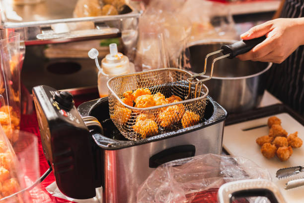 istock Female chef deep fried meat ball in kitchen. 1494205629
