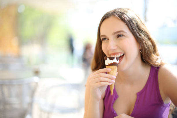 istock Happy woman eating ice cream in a restaurant 1494212666
