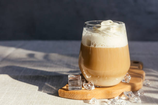 istock Coffee latte on a gray table in bright sunlight and free space. Cold summer coffee with ice. 1494212673