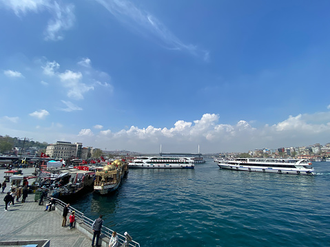 Istanbul, Turkey April 19, 2023  Galata bridge, Eminonu, golden horn view in front of historical Eminönü Fish and Bread boats in Istanbul Turkey