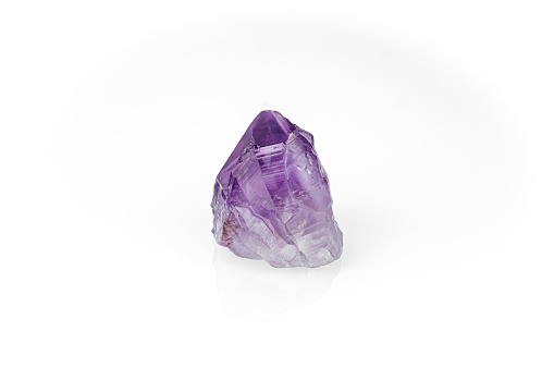 amethyst crystal isolated on white blackground. macro detail  background. close-up Rough raw unpolished semi-precious gemstone