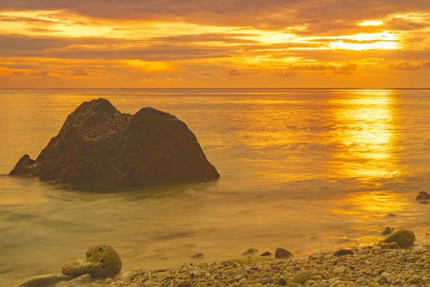 Beach Landscape with rock formation during sunrise on Sumurtiga beach, Sabang, Aceh, Indonesia. Beach Landscape with rock formation during sunrise on Sumurtiga beach, Sabang, Aceh, Indonesia. Long exposure photography. sabang beach stock pictures, royalty-free photos & images